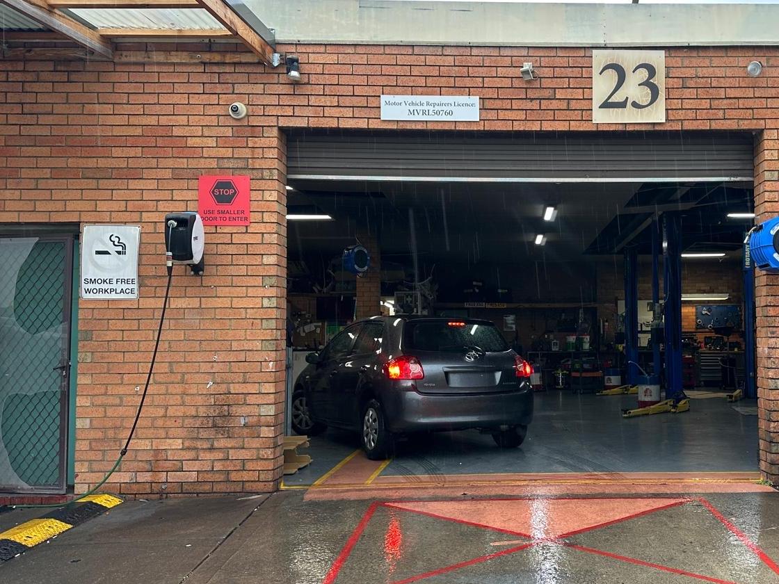 A car driving into the 5AB workshop at 23 Paterson Parade, under the Motor Vehicle Repairers Licence MVRL50760 sign